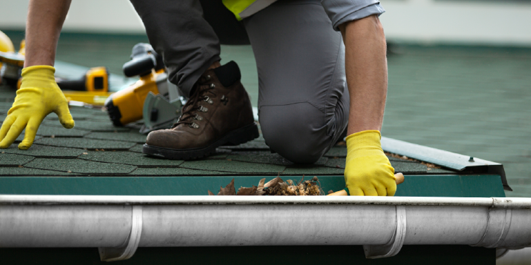 RoofEXT Worker Cleaning Gutters